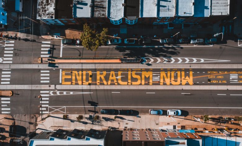 roadway with end racism now title in town
