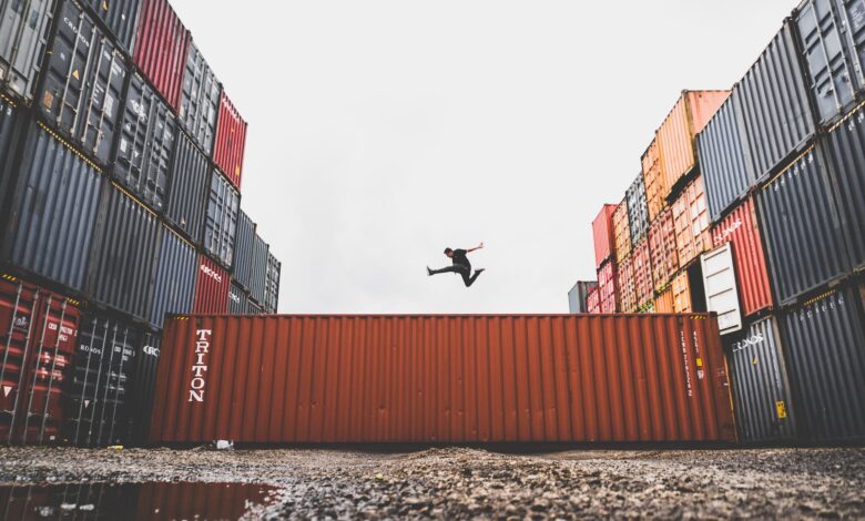 man jumping on intermodal container