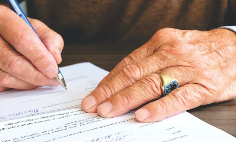 person signing document paper