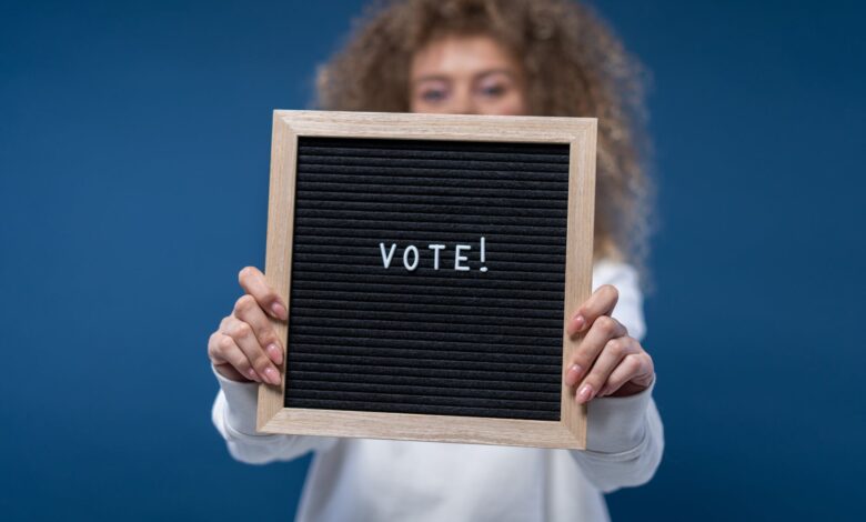 person holding a vote sign